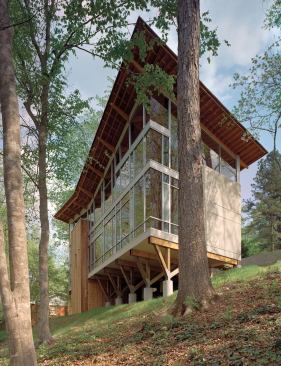 In his design for the Strickland- Ferris Residence, Frank Harmon, FAIA, created a “house in the trees” by raising it off the ground and glazing the expansive wall that faces the woods.