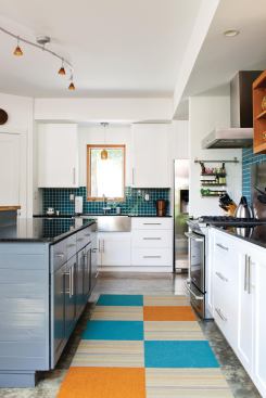 The open kitchen incorporates many sustainable products including Electrolux Energy Star appliances, formaldehyde-free Peachtree cabinets with low-VOC stains and lacquers, and an island made of reclaimed teak.