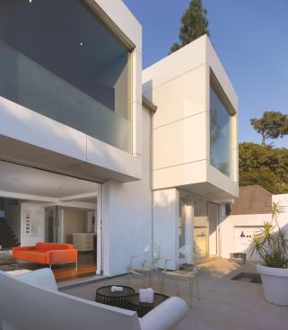 To combine the courtyard sections into a single cohesive space, architect Margaret Griffin removed a center wall. Telescoping doors in the living room help extend the living space into the courtyard, with an easy flow from the living room to the dining room to the fire pit.