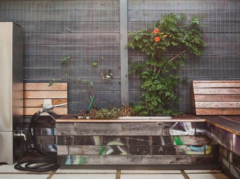 Principal Joshua Otto, AIA, LEED AP, also used the salvaged wood to house built-in planters. A galvanized wire-mesh trellis supports climbing greenery.