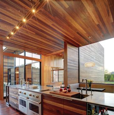 The kitchen island is faced with the same mahogany that covers the building’s interior and exterior walls.