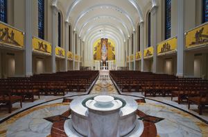 A view from the baptismla font toward the altar shows the chapel's vaulted ceiling.