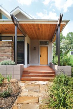 Rainchains on the front porch direct water into a collection cistern, where it is stored until it flows through perforated pipe buried in the planters to keep the flowers irrigated.