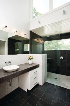 Loaded with windows, the master bathroom facilitates sweeping views of the surrounding area and includes a Danze Parma 1.5-gpm faucet, Kohler Purist 1.75-gpm showerhead, and a dual-flush WaterSense-certified toilet from American Standard.