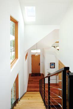 Newcomer designed the home’s staircase and railing, using powder-coated channel steel stringers with welded steel angles to support pine glulam stair treads.
