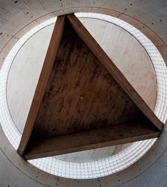 Capping the cylindrical stairwell is a triangular concrete slab,  proof of Kahn's growing interest in monumentality and the power of geometric forms.