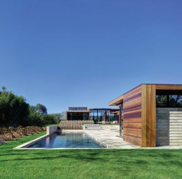Rectilinear planting beds and patios project the architecture’s geometry into the landscape.

