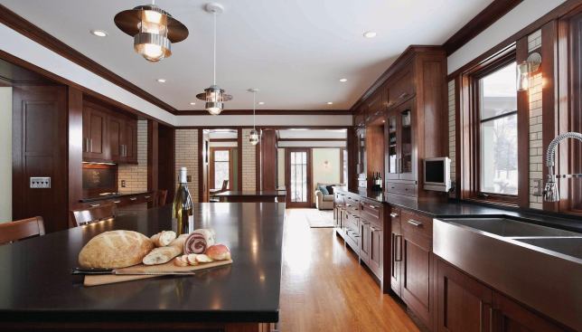 Black basalt counters and stainless steel hardware, appliances, and lighting fixtures lend a subtle contemporary spark.