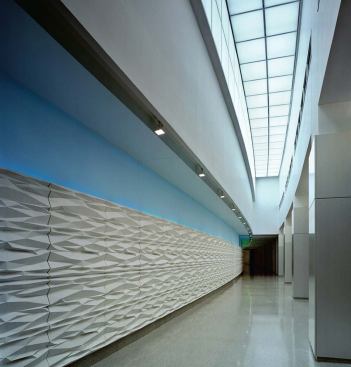 A thoroughfare called "the Street" serves as the main circulation route. A system of bright colors painted on the upper third of the wall indicates the user's location in the 2.5-million-square-foot building.


Strato Panel diffusing system - Philips - www.lighting.philips.com 

Changeable color temperatures and brightness - Simulates daylight and, when applied to the ceiling, skylights - Modular system - Tiles can be installed adjacently


Paint - Sherwin-Williams - www.sherwin-williams.com 

Commercial-grade interior paint - Several hundred colors - Used here to promote wayfinding


Custom-designed GRG wall panel - Formglas - www.formglas.com 

Glassfiber-reinforced gypsum system - Can be factory-molded into any shape or size - Field finished


White terrazzo tile - D. Magnan & Co. 

Marble chips and dust suspended in cement or epoxy resin - Polished and matte-finished available - Variety of color options