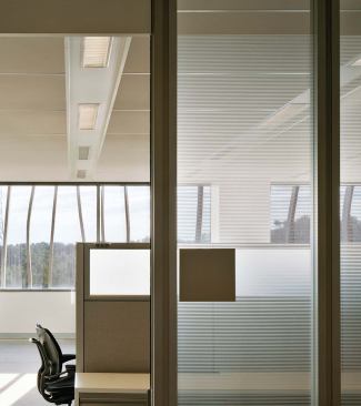 Workspaces are situated near the windows on the perimeter and the interior building's courtyard to maximize daylighting for the workers. 


4' linear fluorescent - Zumtobel - www.zumtobel.com 

Recessed linear fluorescent - Available in 4-, 8-, and 12-foot lengths - White-painted steel upper reflector

Can also be configured for continuous runs


Office front systems with acid-etched glass - Acme Architectural Walls - www.acmearchitecturalwalls.com 

Color can be applied with powder-coat paints - Custom color and acid-etching options available


Optima open-plan plank ceiling - Armstrong - www.armstrong.com

Impact- and soil- resistant panels - Tiles available in square as well as plank - Nondirectional DuraBrite surface increases light reflectance to provide better overall illumination


Morrisson workstations - Knoll - www.knoll.com 

Materials palette includes metals, veneers, and fabrics - Integrated wire management system - Designed by Andrew Morrisson - Freedom Chair Humanscale www.humanscale.com Standard features include self-adjusting recline, dual-pivoting backrest, synchronized armrests, dynamic headrest, and contoured cushions - Upholstery options include 10 different lines of four-way-stretch Humanscale fabrics