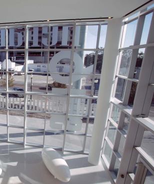 The creased roof of the Sarasota Herald Tribune headquarters is the building's signature. The design takes advantage of the local climate by integrating a deck accessible from the newsroom and by cladding the building in glass, so the sunlight can illuminate the interior during the day.


Downlights - Lithonia - www.lithonia.com 

3-, 5-, 6-, and 8-inch apertures in frame-in models - Galvanized steel frame - Variety of facing options


Azuria low-E coated laminated glass - Viracon - www.viracon.com 

Line of five azurelite low-E insulating glasses - Shading coeffi cients between .44 and .55 depending on tint - ½ -inch thickness - UV transmittance less than 1 percent 


Concrete walkways - SB Ballard - www.sbballard.com 

System of pathways and sidewalks surrounding the building - Specially designed and installed by SB Ballard - Standard and custom tinting options available - Varied finishes


Door Closers - Sargent - www.sargentlock.com 

Forged steel arms - Available in several sprayed metallic finishes - Allows for 140-degree door opening - Separate closing and latching speeds