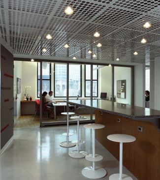 The café area serves as the central hub of the space and allows people to gather informally on their way to and from the surrounding reception area, conference room, and work areas.


Perforated metal ceiling - Diamond Manufacturers - www.diamondman.com 

Perforated carbon and stainless steel, aluminum, and plastic - Over 2,000 patterns - Perforations done on a full-width press - Materials can be formed into a sheet, tube, or coil 


Lytespan pendant fixtures - Lightolier - www.lightolier.com 

Die-cast aluminum socket base with a satin-finish-glass lamp guard for light diffusion - Takes up to a 35 watt Tungsten halogen capsule lamp - Eight lamp guard options 


Enclose wall system - Haworth - www.haworth.com 

Tilt-up moveable wall system - Interchangeable surface skins - Easy access to horizontal raceways makes technology changes easier - 4-inch-thick platfor - Complements Compose system of open-plan panels


Recycled composite material countertop - Alkemi - www.alkemi.com 

Uses 60 percent postconsumer scrap aluminun - Can be finished matte or buff ed to high gloss - 12 color options. 