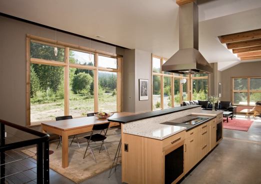 The utilitarian kitchen layout flows seamlessly into dining, living, and outdoor spaces, resulting in a laid-back floor plan that fosters togetherness.