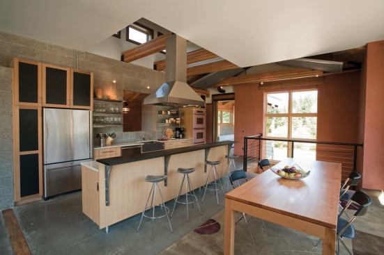 Concrete plays a central role in this eco-friendly kitchen. The walls' open-face concrete block is a rugged counterpoint to the gleaming wax finish on the concrete floors and the sparkle of glass-flecked, polished-cement countertops.