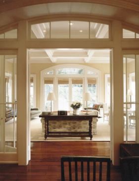 In contrast to many old-house additions that step suddenly from a small doorway to a bright room, Muse thinks about how it works its way back through the house. Here, the exterior wall's arched opening is repeated at the edge of the existing house, openin