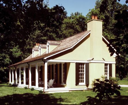 The long wood-shingle roof and lean-to porch of this simple stucco home near Middleburg, Va., reflect local Piedmont architecture.