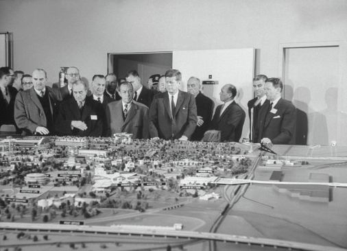 Robert Moses (fourth from right), in his role as president of the New York World's Fair 1964-65 Corp., watches as President John F. Kennedy inspects a model of the fairgrounds.