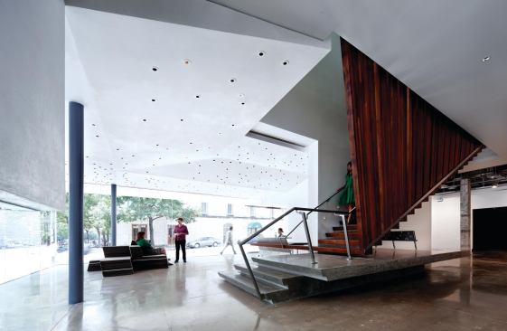 The building opens directly to the busy intersection by way of a series of floor-to-ceiling windows at the Arthouse's entrance.