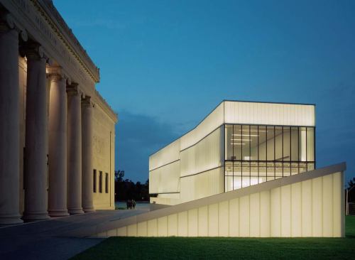 The solid limestone edifice of the original Nelson-Atkins Building with one of the Bloch Building's five "lanterns," designed by Steven Holl.