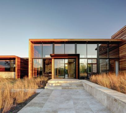 The entry walk’s travertine surface flows through the central pavilion to the backyard’s patio and pool deck.