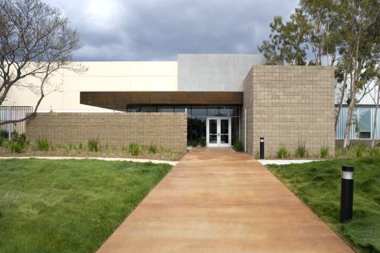 At more than 300,000 square feet, how could the warehouse addition be least conspicuous? Ehrlich's office tailored each facade to respond, modestly, to interior functions. On the west side, a low Cor-Ten steel canopy shelters the entry and break room, while a softscape of native grasses obscures the building's bulk.