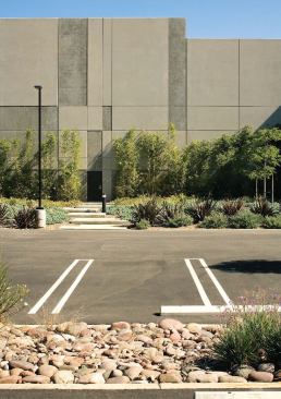Tilt-up concrete, installed in panels 30 feet wide by 45 feet high, clads the south façade. Variations in the formwork give texture to the long expanse and make a design element out of a lowly fire exit.