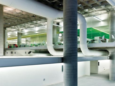 Exposed ductwork snakes under and around the newly reworked floor plates.