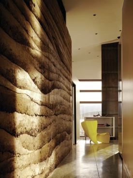 The site itself supplied the rammed earth’s principal material, a sandy loam excavated only steps away. A two-inch core of rigid foam insulation provides a thermal break.