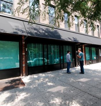 For its new office, Focus Lighting joined three separate buildings on West 116th Street, giving the lighting firm a unique storefront and street presence on a busy Harlem thoroughfare (bottom right). With ample space, the new office has room for an informal staff meeting-lunch area (top right) and a double-height mock-up area that, by all accounts, can function as a small black box theater (far left). Natural light permeates the space thanks to a system of 45 tubular skylights. Electric light sources are used to supplement the natural light in the work area, which brings the staff of 25 together in one space as opposed to the seven different areas, as when the office was divided at its former location on West 101st Street. Lighting and HVAC equipment each have their own breaker panel installed in the basement so that each load can be monitored and tracked separately via a data logger. The commercial-grade data logger is a small box measuring 5-inches-square and only cost a few hundred dollars, a small investment for the firm to track its energy use. To make sure the office design would meet the applicable energy code stipulations (90.1-2004), Focus Lighting used the COMcheck software program to make sure each space was in accordance with its interior lighting and power needs. Not only does the lighting comply, but the design is 23.9 percent better than allowable code levels.