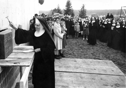 With a sprinkling of holy water, Sister Henrita Osendorf blesses the cornerstone of the original center in 1964.
