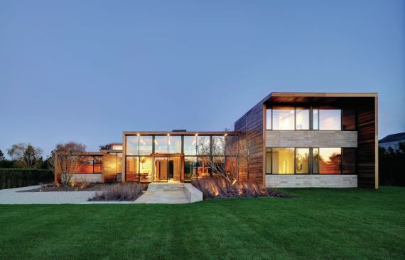 A glass-walled living-and-dining pavilion is flanked by wings holding more private spaces.