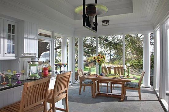 The sunny screened in porch has water views.