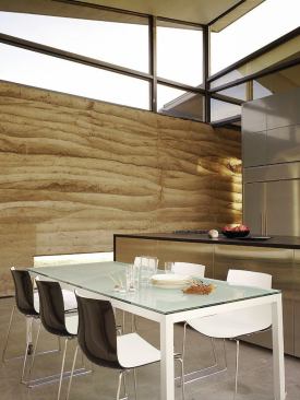 A rammed earth wall runs the length of the great room and into the master suite, screening unwanted southerly views while contributing substantial thermal mass to the house