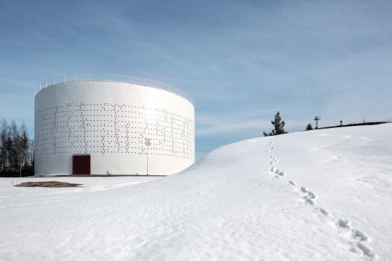 During the day, the tank's appearance changes and the matrix of perforations recede against the bright white steel surface.