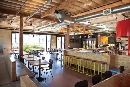 Bestor transformed a former Shakey's pizza parlor into the hip artisanal pizza restaurant Pitfire. Strong colors, exposed plywood and custom furniture give the space a high-design feel without sacrificing, the brands casual, family-friendly style.