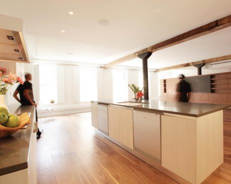 Living room, den, and kitchen are organized on the east side where they benefit from the natural light and views on the west side.