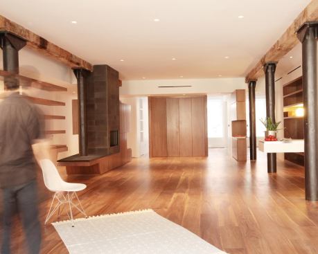 Freestanding walnut cabinetry and cantilevered wet bar help define the space.