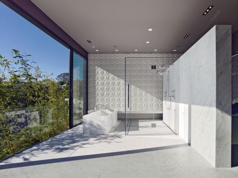 A wall in the luminous master bath is covered in Ann Sacks tile.
