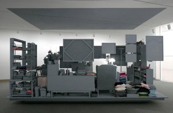 At the Weatherspoon Art Museum, Lead Pencil Studio installed a full-scale exact reproduction of a one-bedroom apartment room. All personal belongings were painted a dull gray.