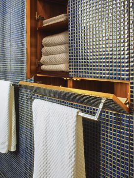 Clever built-ins and features such as a hidden hamper help the space live large.