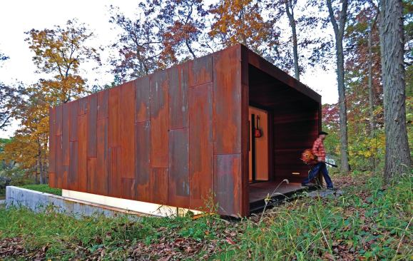 This building’s rusty metal shell was inspired by picturesque abandoned farm implements in the surrounding forest.