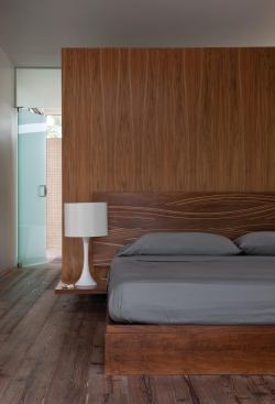 Glass doors and a glass clerestory surround the millwork element.