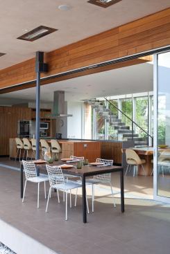 A wall of sliding glass doors opens the kitchen to a covered veranda.
