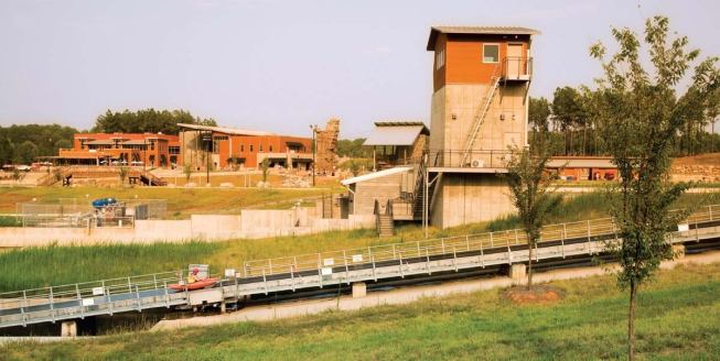 A conveyor whisks kayaks and rafts from the lower pond to the upper pond.