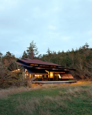 A system of lifting steel shutters protects this vacation home from intruders and the elements. 
