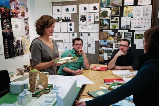 Jeanne Gang, FAIA, leads a project meeting with (left to right) Stephen Claeys, Weston Walker, and Beth Zacherle. The group is discussing a mixed-use project for Mumbai, India, and debating, specifically, how the project's base will meet the ground. In this session, the group resolved to combine elements from two preliminary models to move forward. Even at an early design stage, Studio Gang's engagement with topography is evident. The first monograph on Studio Gang, Reveal, to be published this month by Princeton Architectural Press, reveals the process behind eight projects—including key hometown works such as the Aqua Tower, a residential skyscraper near the Chicago River, and the SOS Children's Villages in Chicago's reemerging South Side.