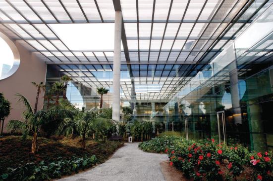 An indoor-outdoor garden brings greenery into the stone complex.