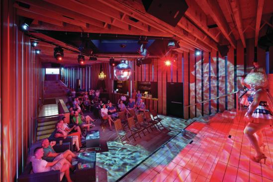 The dance-floor is often packed full during weekend parties in the summer season. But, flanked by bleachers on both ends, the cedar-lined space can also double as a performance venue.