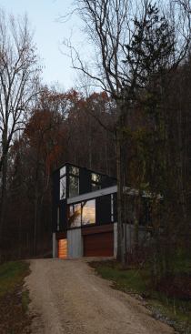A winding dirt road leads up to the home.