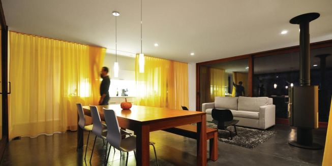 The interior is essentially a large open room bracketed by a galley kitchen and sleeping rooms.